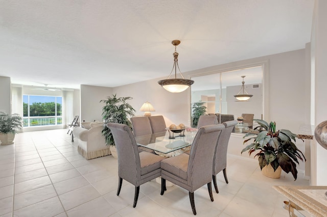 dining space featuring light tile patterned flooring