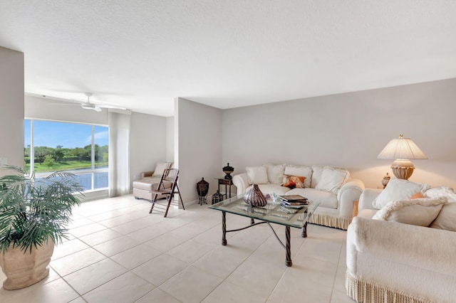 tiled living room with a textured ceiling and ceiling fan