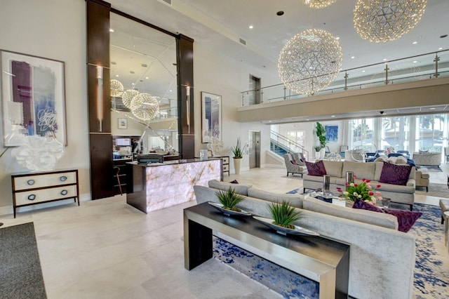 living room featuring a towering ceiling and a notable chandelier