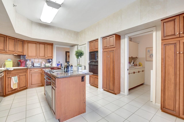 kitchen featuring black appliances, brown cabinetry, and a kitchen island