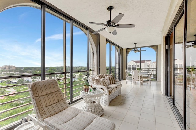 sunroom with ceiling fan and plenty of natural light