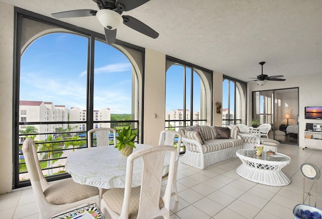 sunroom / solarium with a ceiling fan