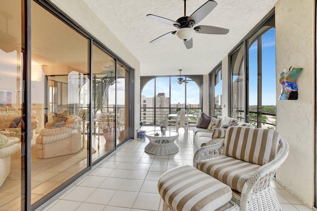 sunroom / solarium with a view of city, a wealth of natural light, and a ceiling fan