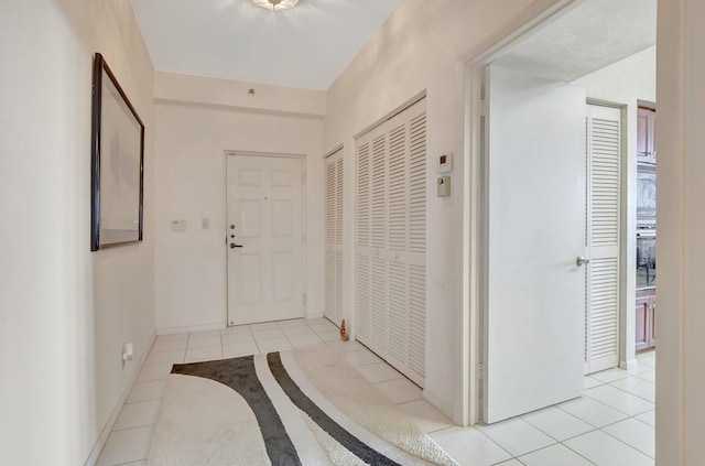 hall featuring light tile patterned flooring