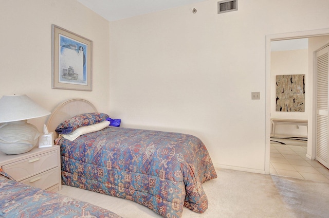 bedroom featuring light carpet, visible vents, and baseboards