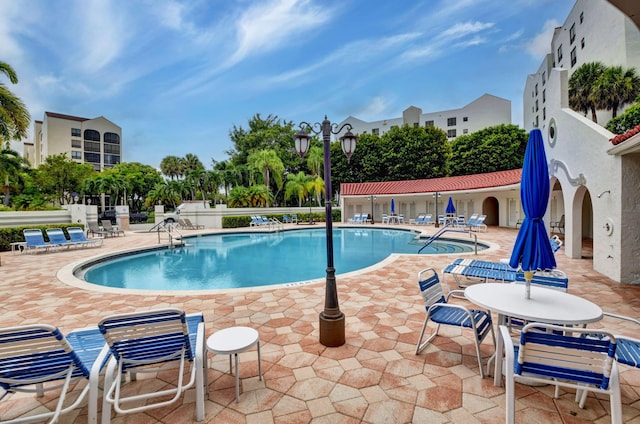 pool featuring a patio and fence