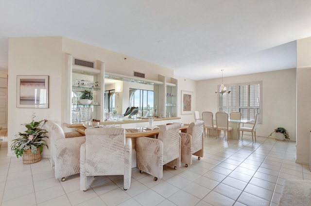 living area featuring an inviting chandelier, visible vents, and light tile patterned flooring