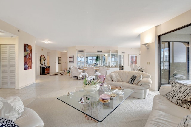 living area with light tile patterned flooring and visible vents