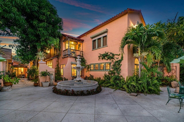 mediterranean / spanish house with a patio and a balcony