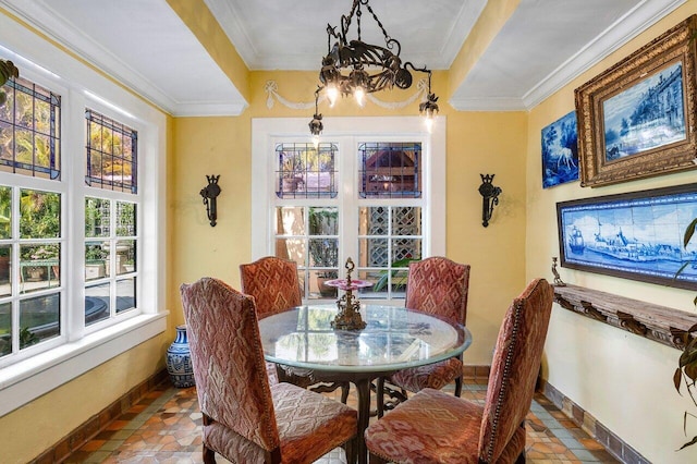 dining area featuring crown molding, a notable chandelier, and tile patterned floors