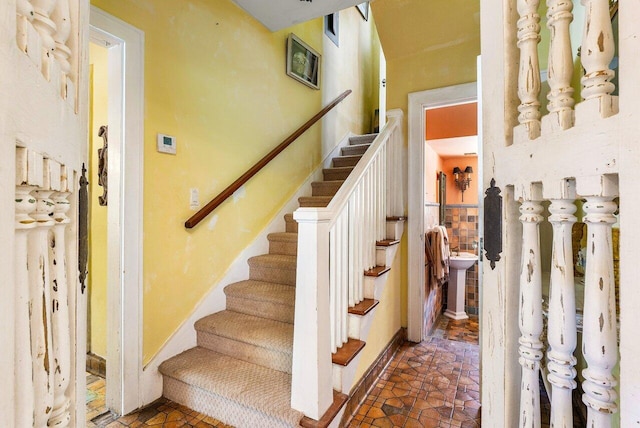 staircase with sink and tile patterned flooring