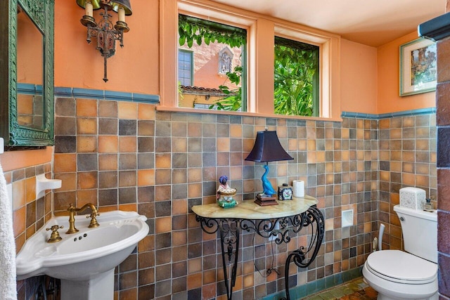 bathroom featuring tile walls, tile patterned floors, backsplash, and toilet