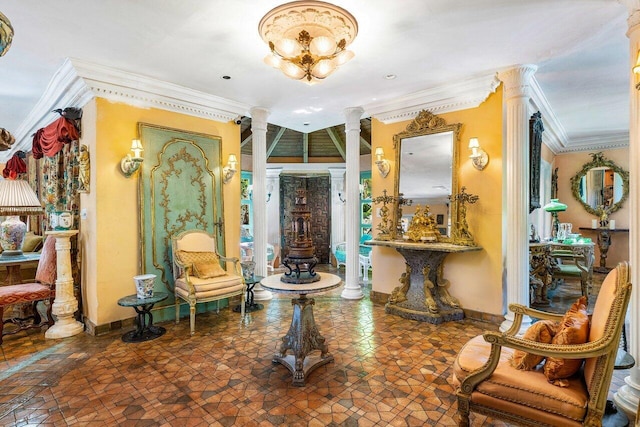 foyer entrance with ornamental molding, a chandelier, dark tile patterned flooring, and ornate columns