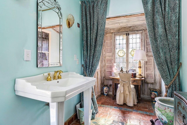 bathroom featuring wood walls