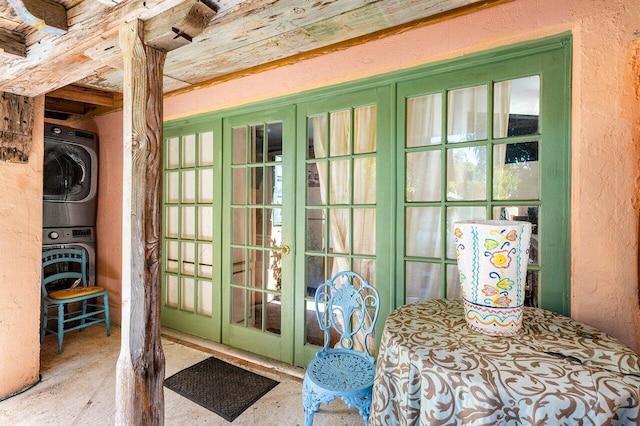 entrance to property with stacked washer and clothes dryer and french doors