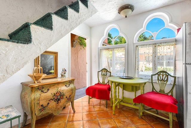 sitting room with a textured ceiling and tile patterned floors