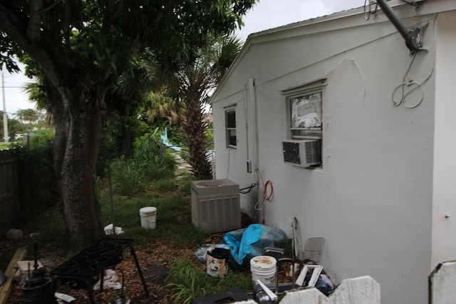 view of side of property with central AC unit and cooling unit