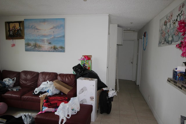 tiled living room featuring a textured ceiling