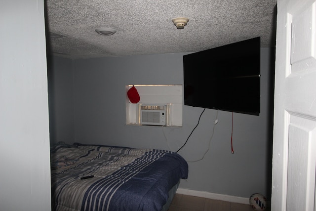 bedroom featuring a textured ceiling and cooling unit