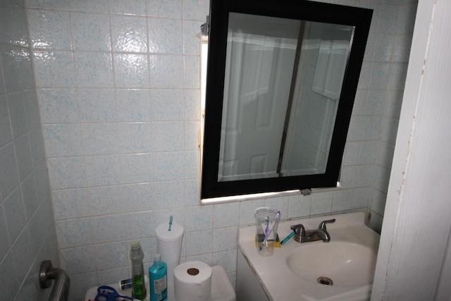 bathroom featuring vanity, tile walls, and decorative backsplash