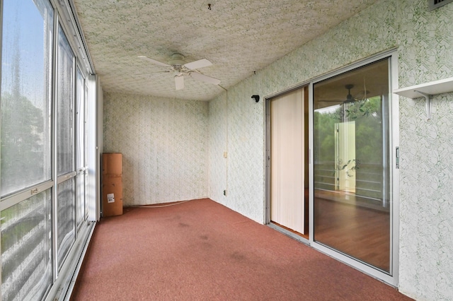 unfurnished sunroom with ceiling fan and a wealth of natural light