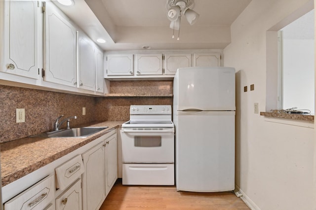 kitchen with ceiling fan, a sink, white appliances, white cabinetry, and light wood-type flooring