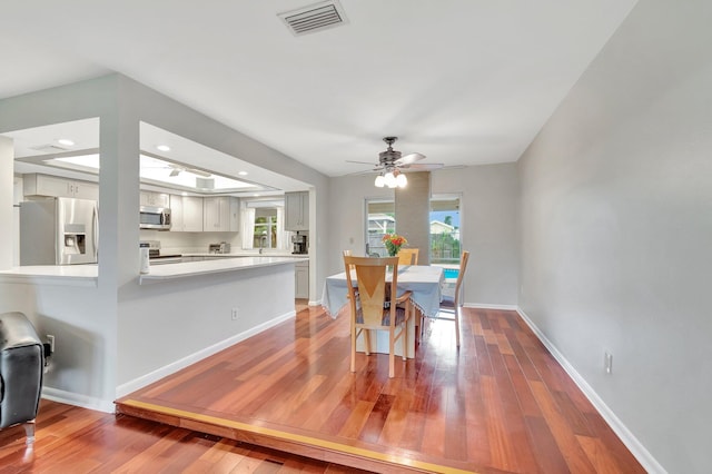 dining area featuring hardwood / wood-style floors and ceiling fan