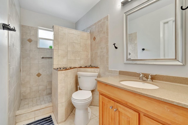 bathroom with tile walls, vanity, tile patterned floors, and tiled shower