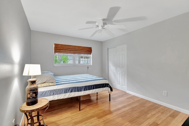 bedroom featuring hardwood / wood-style floors, ceiling fan, and a closet