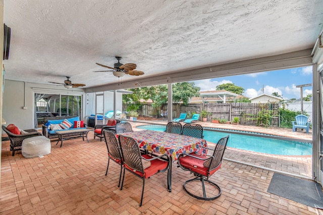 exterior space with ceiling fan, a patio, and an outdoor living space