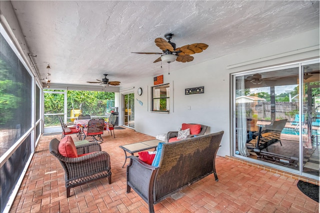 sunroom / solarium featuring ceiling fan