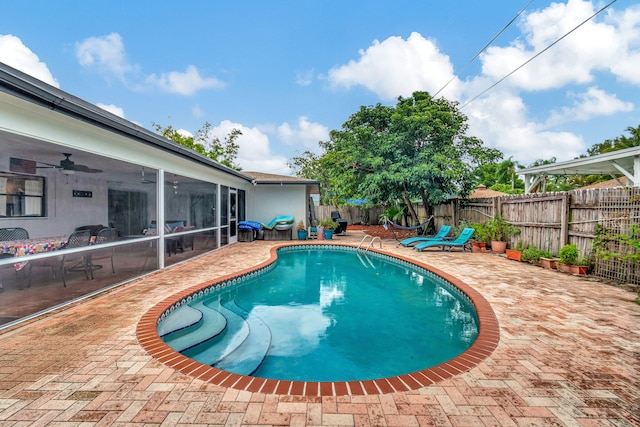 view of swimming pool with a patio area and ceiling fan