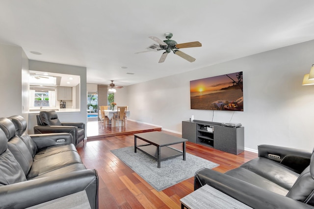 living room with hardwood / wood-style floors and ceiling fan