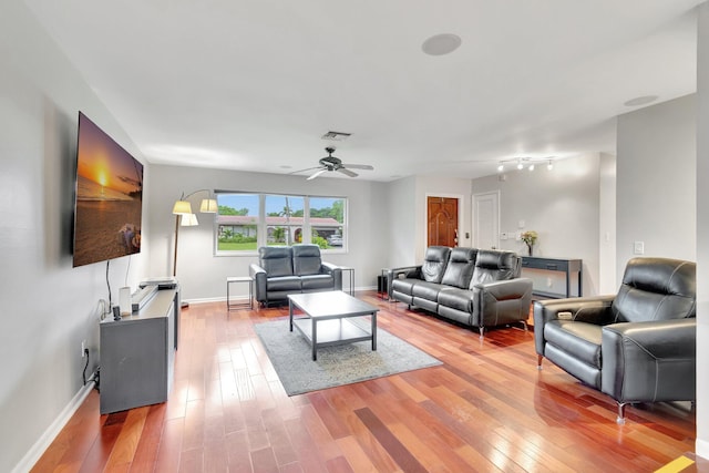 living room featuring hardwood / wood-style flooring and ceiling fan