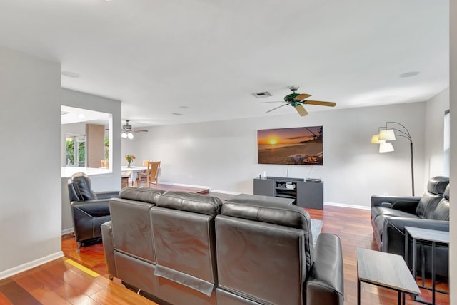 living room featuring light wood-type flooring and ceiling fan