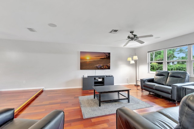 living room featuring ceiling fan and wood-type flooring