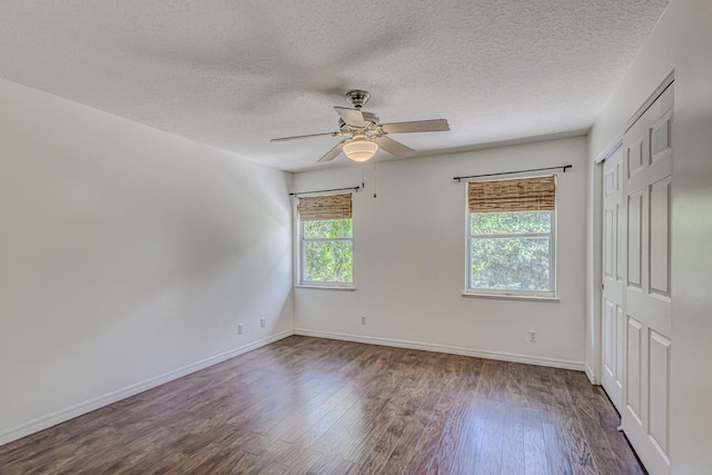 unfurnished bedroom with ceiling fan, hardwood / wood-style flooring, and a textured ceiling