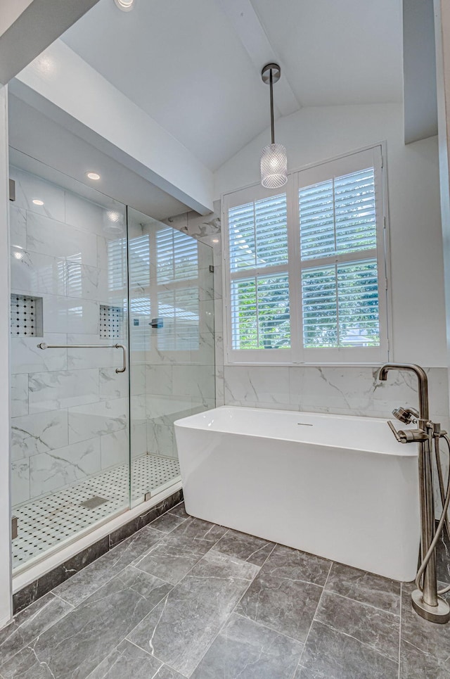 bathroom with tile patterned floors, independent shower and bath, and vaulted ceiling