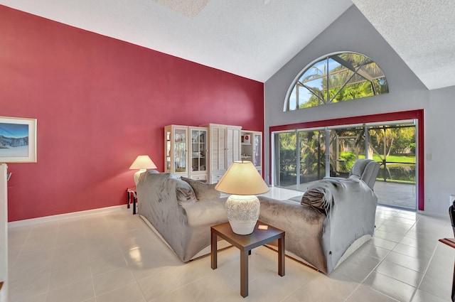 living room featuring light tile patterned floors, a textured ceiling, and high vaulted ceiling