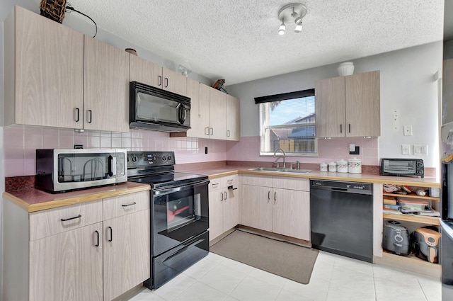 kitchen featuring tasteful backsplash, sink, black appliances, and light brown cabinets