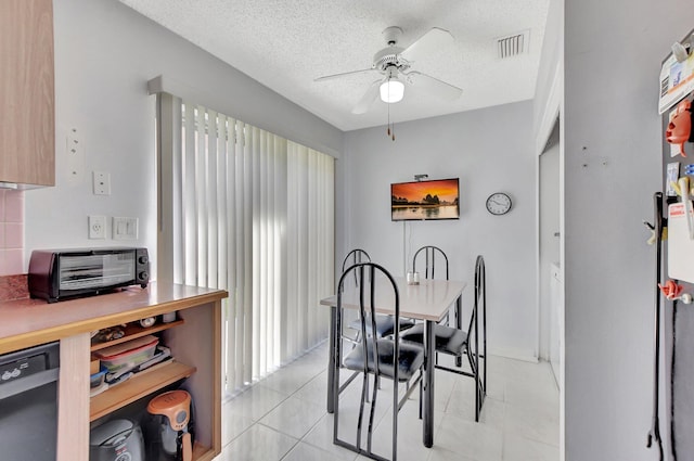 dining area with light tile patterned floors, a textured ceiling, and ceiling fan