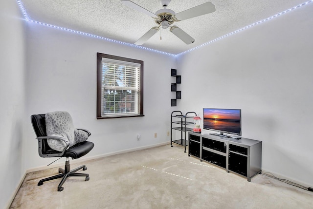 sitting room with light carpet, ceiling fan, and a textured ceiling