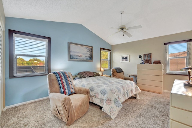 bedroom featuring ceiling fan, light colored carpet, lofted ceiling, and a textured ceiling