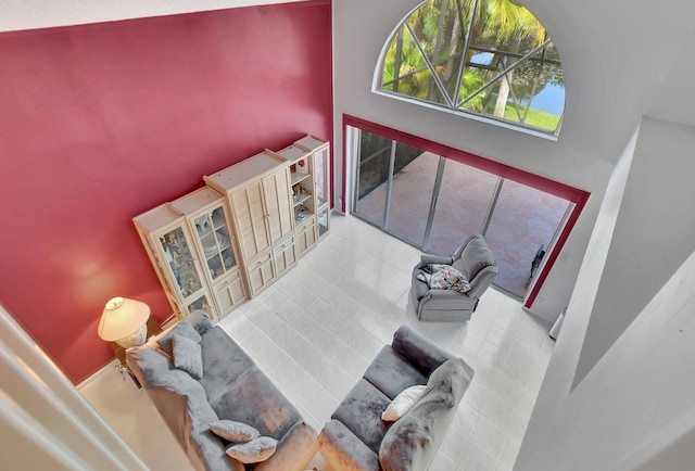 tiled living room with a towering ceiling