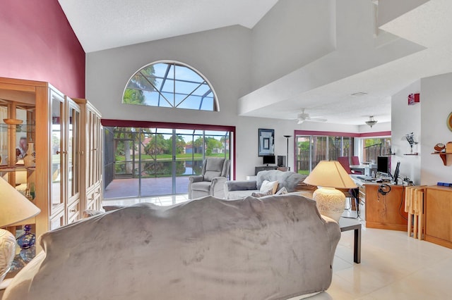 tiled living room featuring a towering ceiling, a textured ceiling, and ceiling fan