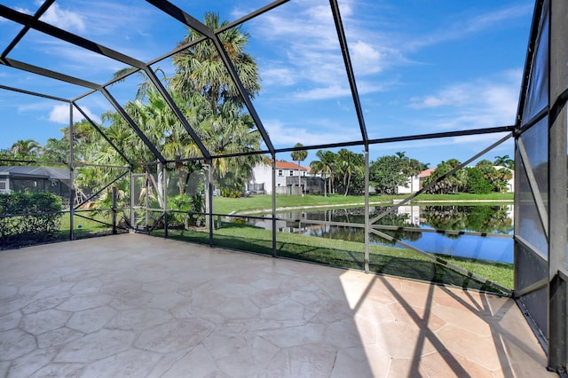 view of patio with a lanai and a water view