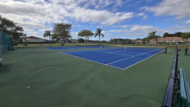 view of tennis court featuring basketball hoop