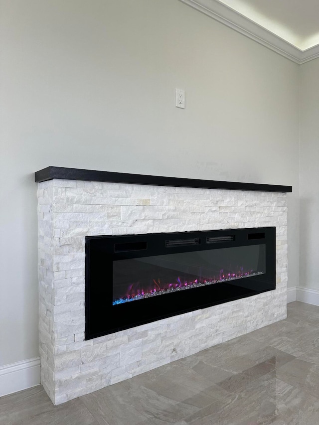 interior details with crown molding and a fireplace