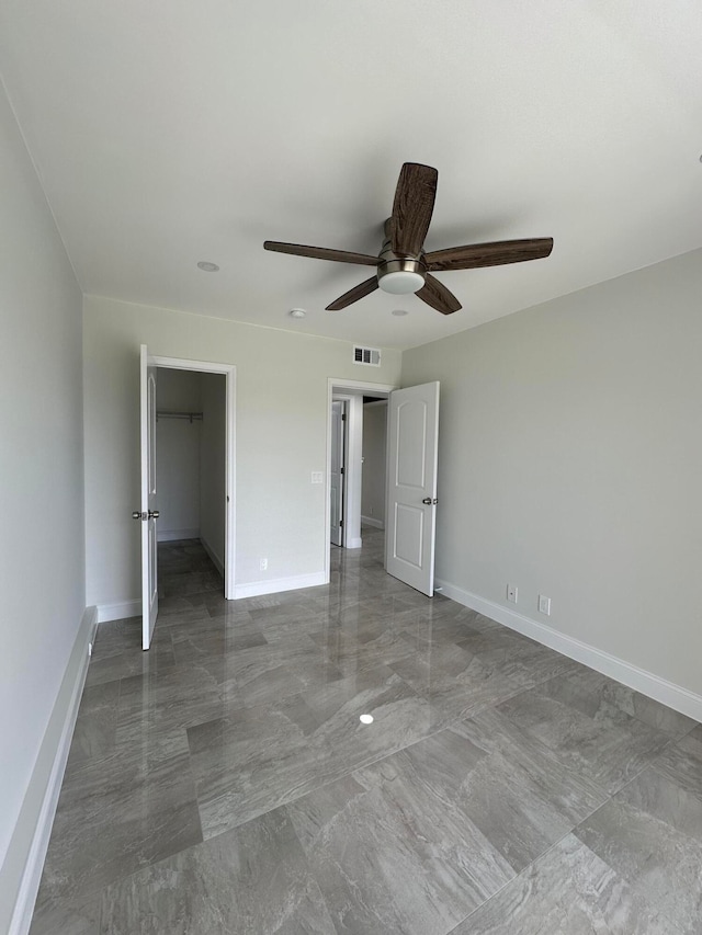 unfurnished room featuring tile patterned flooring and ceiling fan