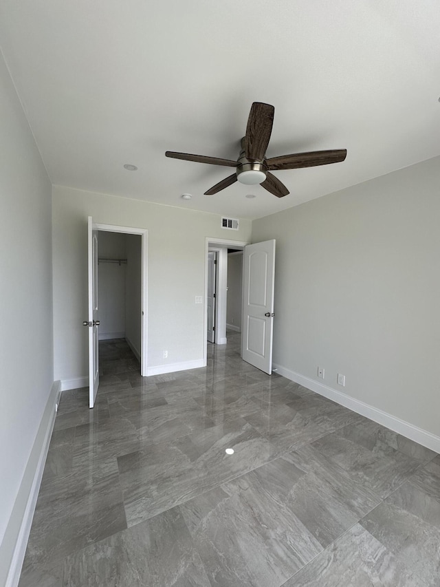 unfurnished bedroom with ceiling fan, visible vents, and baseboards